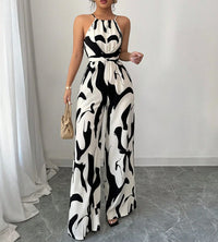 Woman wearing a black and white patterned dress in a minimal indoor setting.
