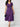 Woman wearing a purple dress with a white background