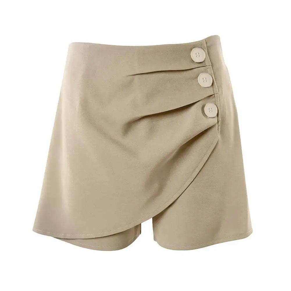 A pair of high-waisted, asymmetric cut women's summer shorts in a light solid color, featuring a button detail on the side.