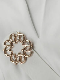 Gold bracelet on a light gray background