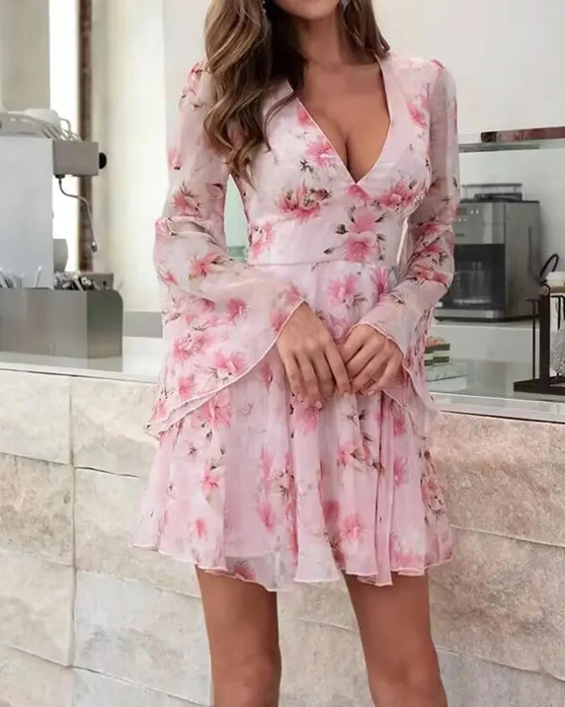 Woman wearing a pink floral dress in a kitchen setting